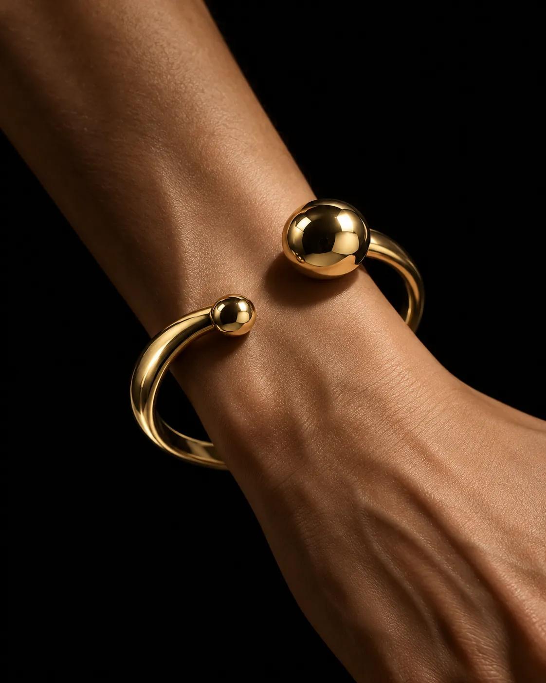 Orbit Cuff, an open oval of polished gold